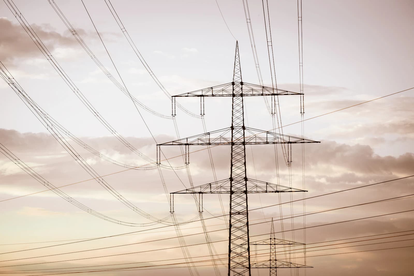 Electricity transmission towers and power lines at sunset